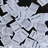 "Graysmatter three day trial packets scattered on a black surface."