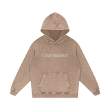 Graymatter limited edition white logo hoodie on a beige background.